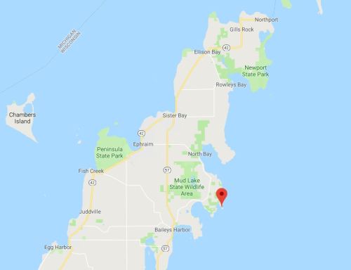 Map of Door County, Wisconsin, highlighting various towns and parks, with a red marker indicating a specific location.