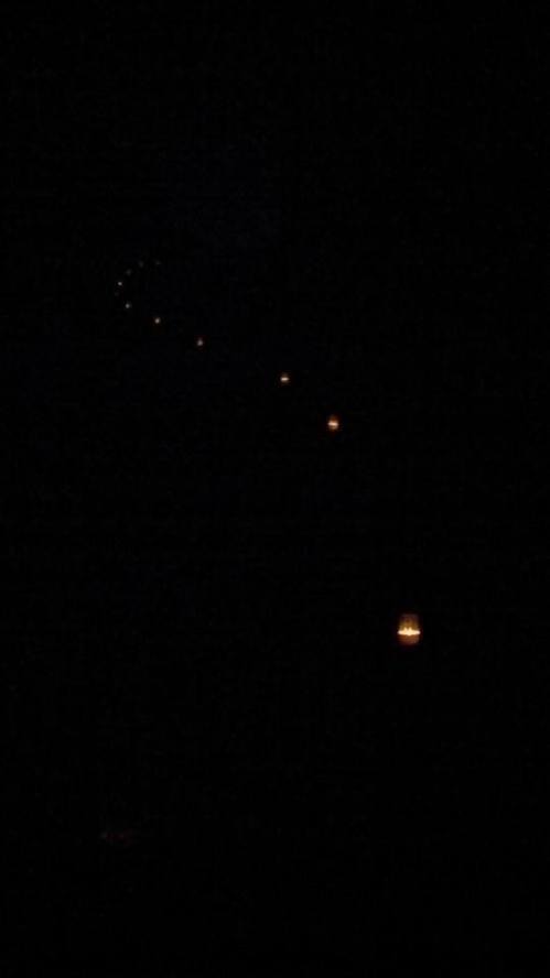 Dimly lit scene with several small lights in a dark background, creating a mysterious and atmospheric effect.