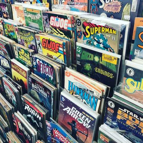 A colorful display of comic books featuring various superheroes and titles, neatly arranged on shelves.