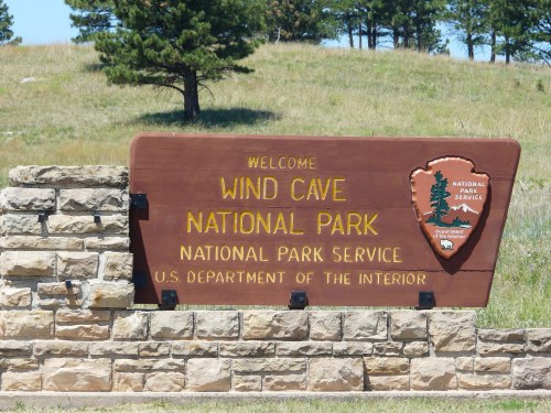 Welcome sign for Wind Cave National Park, featuring the National Park Service logo and stone base.