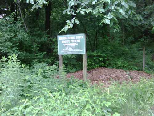 Sign for the Virginia Lee Burwell Wildlife Preserve, surrounded by greenery and trees.