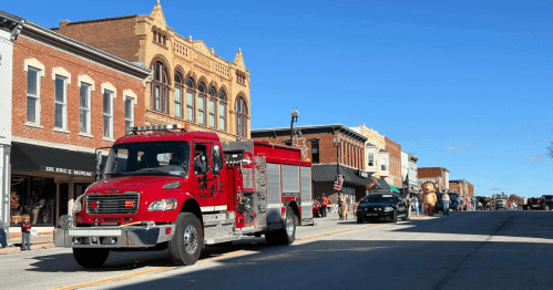a red fire truck leads the parade at the Hiawatha Halloween Frolic in kansas