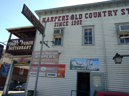 Exterior of Harpers Old Country Store, featuring signs for a restaurant and tourist information, with a rustic wooden facade.