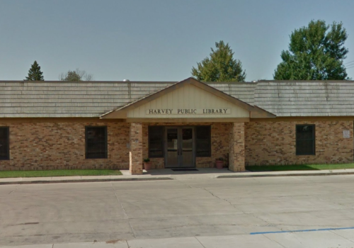 Exterior view of the Harvey Public Library, featuring a brick facade and a sloped roof.