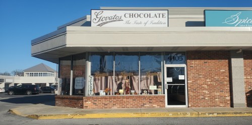 Exterior of a chocolate shop named "Gorata's Chocolate," featuring a welcoming entrance and large windows.