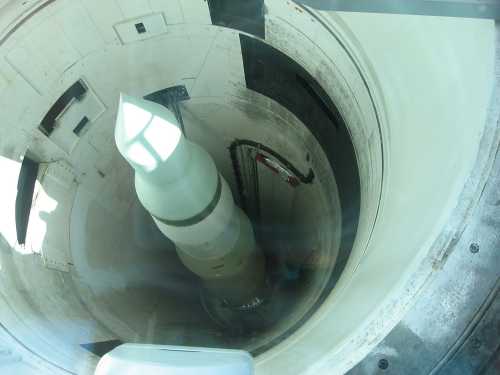 A top-down view of a missile inside a launch silo, showcasing its cylindrical shape and surrounding structure.