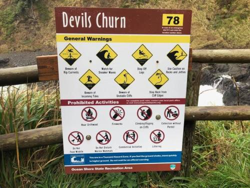 Sign at Devils Churn with warnings about safety, hazards, and prohibited activities for visitors. Ocean Shore State Recreation Area.