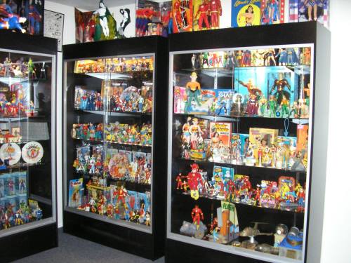 Display cases filled with various action figures and collectibles, showcasing a vibrant collection of superhero memorabilia.