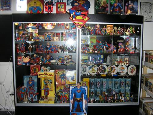 A display case filled with various Superman collectibles, including action figures, toys, and memorabilia.