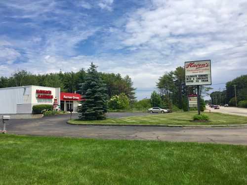 A roadside view of Flaver's Casino and Store, featuring a green lawn and trees under a cloudy sky.