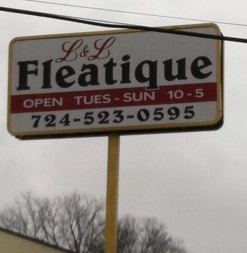 Sign for L & L Fleatique, open Tuesday to Sunday, 10 AM to 5 PM, with phone number 724-523-0595.