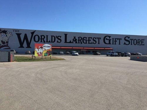 Exterior of a large gift store with a sign reading "The World's Largest Gift Store" and a welcome sign in front.