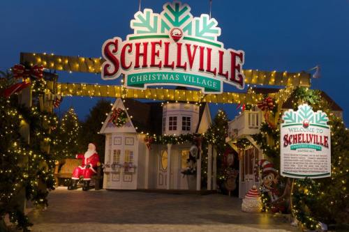 Entrance to Schellville Christmas Village, adorned with festive lights and decorations, featuring Santa and holiday displays.