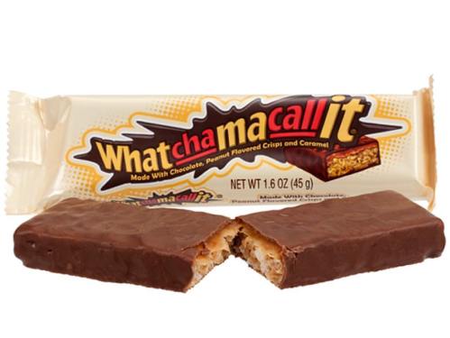 A What-a-chama-call-it candy bar, partially broken, showing its chocolate coating and crispy, caramel-filled interior.