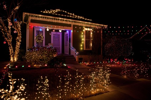 A beautifully decorated house at night, adorned with colorful Christmas lights and festive ornaments.