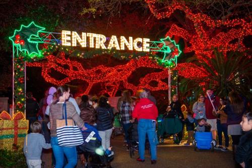 A festive entrance adorned with holiday lights and decorations, bustling with families and children.