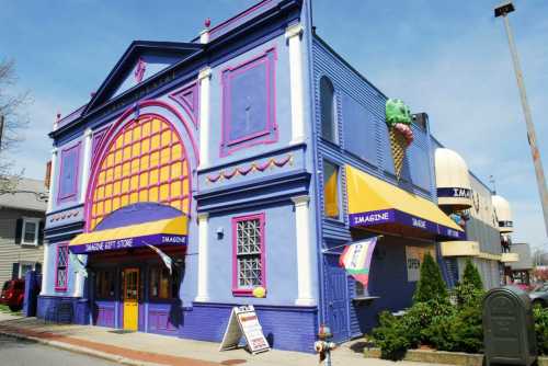 Colorful building with purple and yellow exterior, featuring an ice cream cone sign and "Imagine Gift Store" entrance.