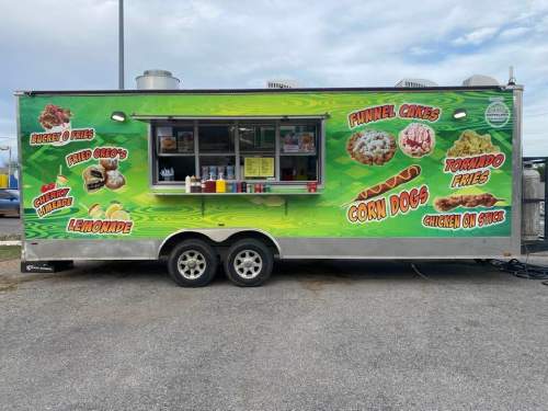 A colorful food truck featuring a menu with funnel cakes, corn dogs, lemonade, and more.