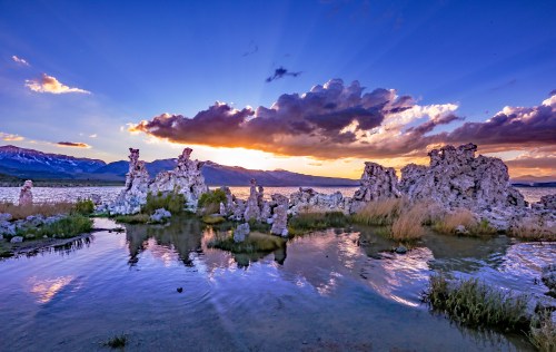 Sunset over Mono Lake, featuring unique rock formations and reflections in the water, with colorful clouds in the sky.