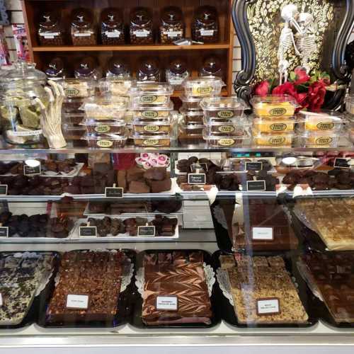 A display of assorted chocolates and confections in a shop, featuring various shapes and flavors.