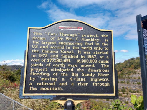 Historical marker about the "Cut-Through" project by Dr. Wm. C. Hambley, detailing its significance and impact.