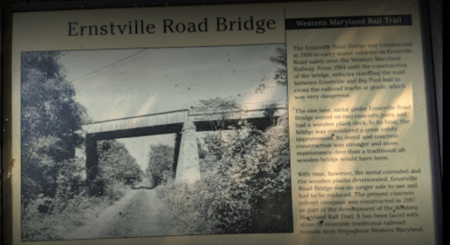 Black and white photo of Ernstville Road Bridge, with a historical plaque detailing its construction and significance.