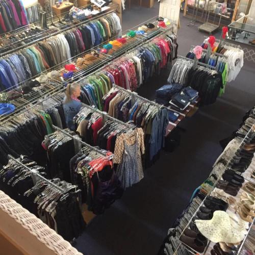 Aerial view of a clothing store with racks of colorful clothes and a person browsing among them.