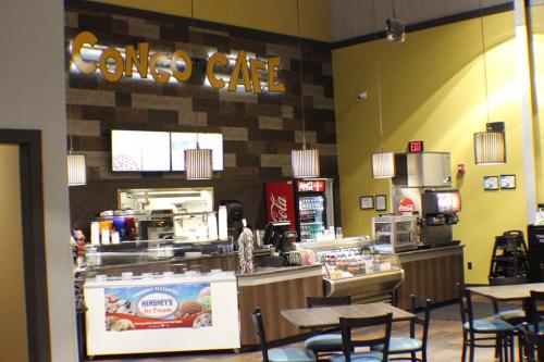 Interior of Conso Café featuring a service counter, seating area, and decorative lighting.