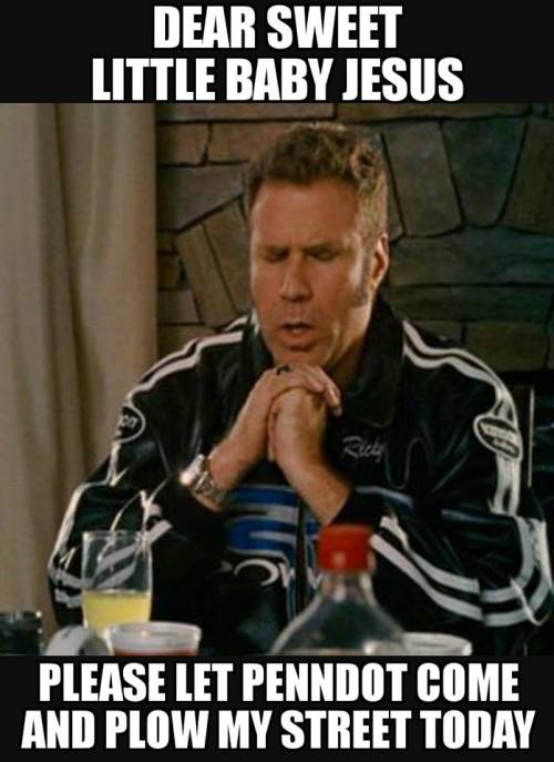 A man in a jacket prays at a table, asking for snow plowing help from PennDOT.
