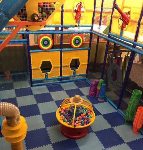 Colorful indoor play area with ball pit, targets, and climbing structures, designed for children's fun and play.