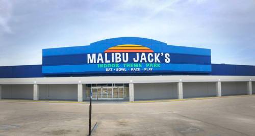 Exterior of Malibu Jack's Indoor Theme Park, featuring a colorful sign and a clear sky.