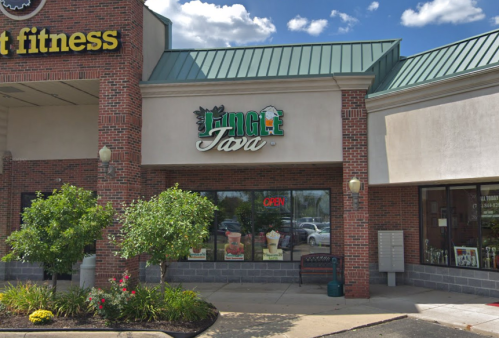 Exterior view of a coffee shop named "Jungle Java," featuring an open sign and greenery in front.