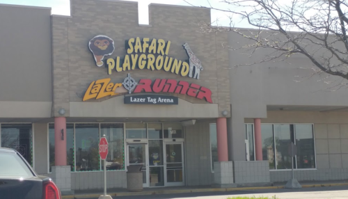 Exterior of a building featuring a sign for "Safari Playground" and "Lazer Runner" laser tag arena.