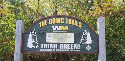 Sign for the Gonic Trails, featuring the Waste Management logo and the phrase "Think Green!" surrounded by trees.