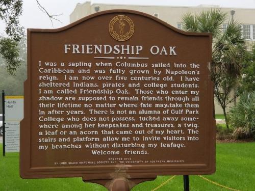 Sign describing the Friendship Oak, a historic tree in Mississippi, detailing its history and significance.