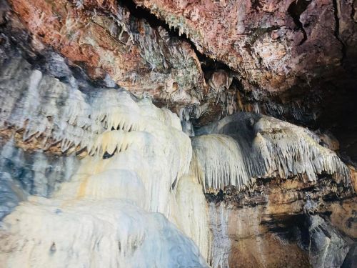 Stalactites and stalagmites in a cave, showcasing unique rock formations and textures.