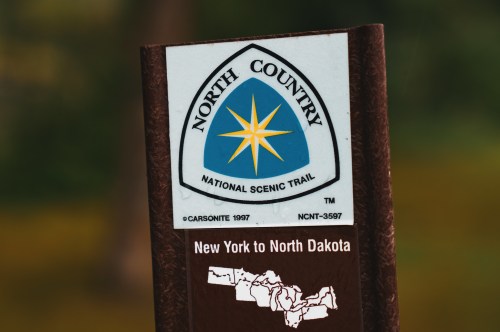 Sign for the North Country National Scenic Trail, indicating the route from New York to North Dakota.