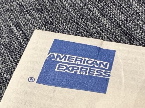 Close-up of an American Express logo on a textured surface.