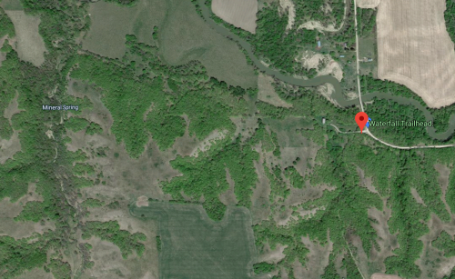 Aerial view of a green landscape with a marked location for Waterfall Trailhead and nearby Mineral Spring.