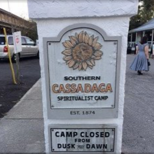 Sign for Southern Cassadaga Spiritualist Camp, established in 1874, stating "Camp Closed from Dusk to Dawn."