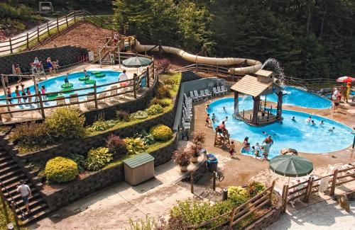 Aerial view of a water park with pools, slides, and people enjoying the sun and water activities.