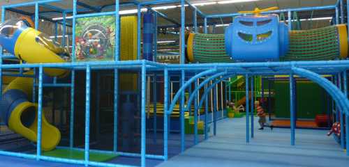 Colorful indoor playground with slides, climbing structures, and play areas for children.