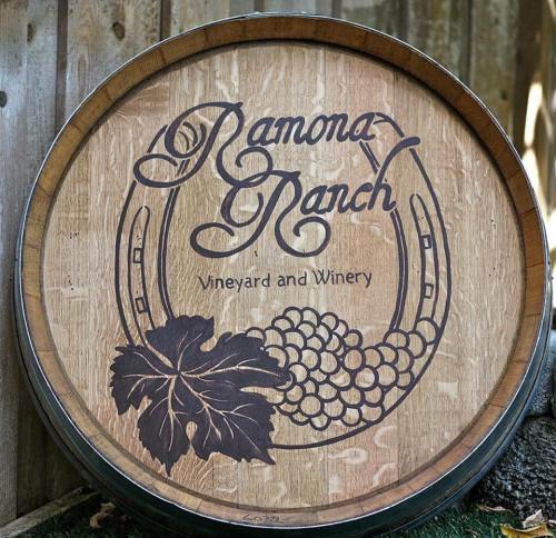 Wooden wine barrel with the engraved text "Ramona Ranch Vineyard and Winery" and a grapevine design.