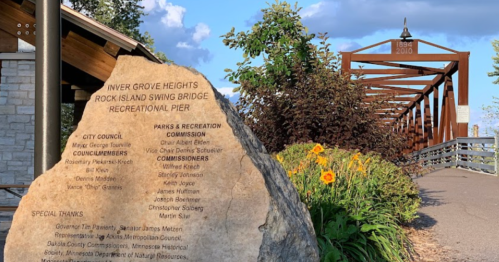 A stone monument lists city officials and special thanks near the Rock Island Swing Bridge Recreational Pier in Inver Grove Heights.