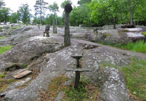 A rocky landscape with unique stone formations and trees, creating a natural, serene environment.