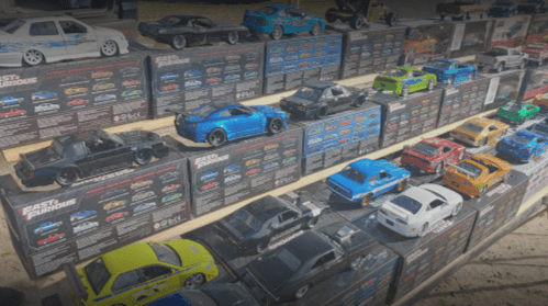 A display of various toy cars from the "Fast and Furious" series, arranged on shelves with colorful packaging.