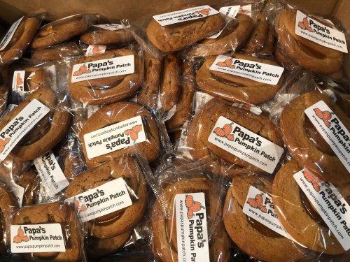 A box filled with individually wrapped cookies labeled "Papa's Pumpkin Patch."