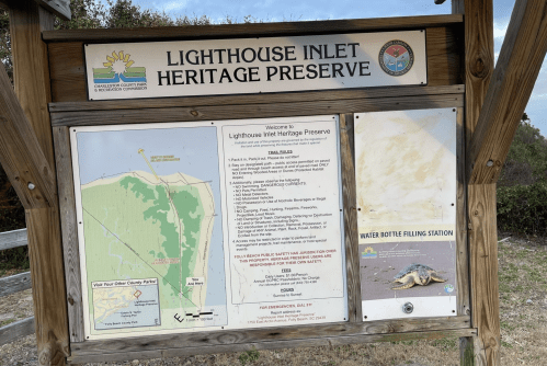 Sign at Lighthouse Inlet Heritage Preserve with map, rules, and information about water bottle filling station.