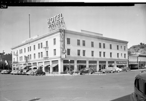 Historic black-and-white photo of Hotel McKassen in Susanville, California, featuring classic cars and a vintage sign.