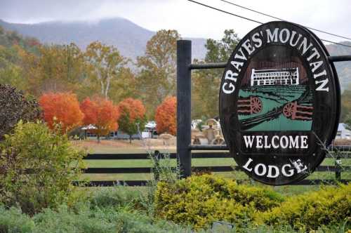 Sign for Graves' Mountain Lodge with colorful autumn trees and mountains in the background.